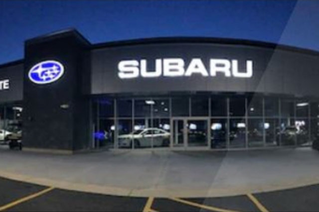 Front view of Schulte Subaru building at night.