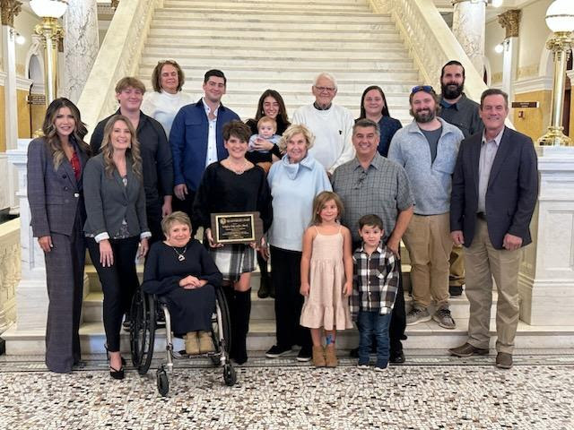 A group photo of Governor Kristi Noem, Deputy Secretary Shawnie Rechtenbaugh, EDR executive director Vicki Stewart and family and friends of Yakkity Yak Coffee Shack, the winner of the Outstanding Small Private Employer for this year's Governor's Awards.