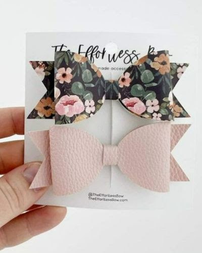 A deep foliage and pink floral bow paired with a solid pink bow.